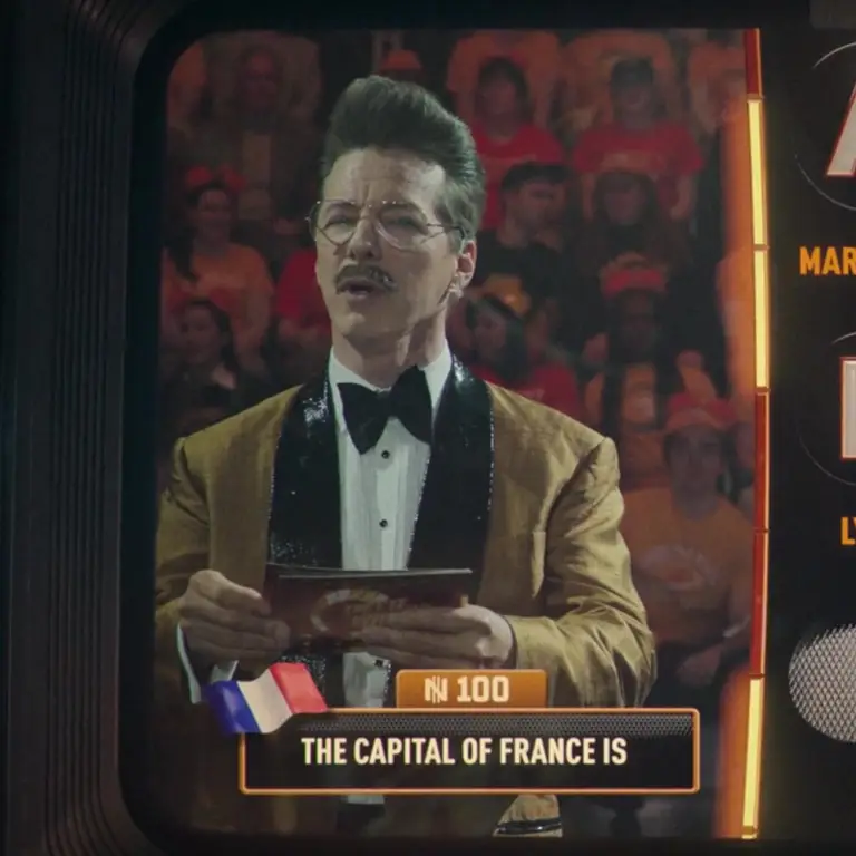 Sean Hayes as Gary Greenbacks in The Running Man